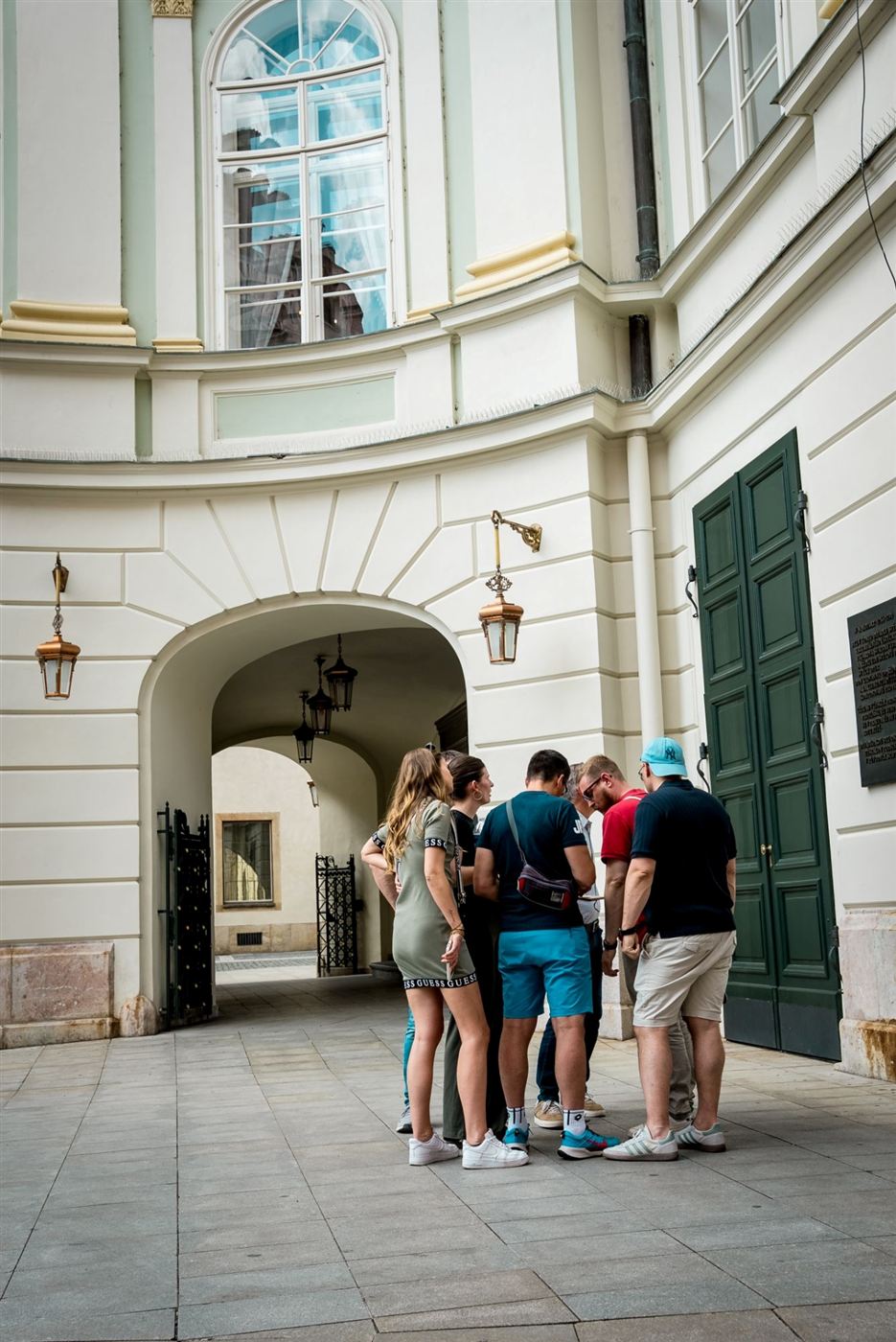 A team working out a puzzle in an Old Town courtyard