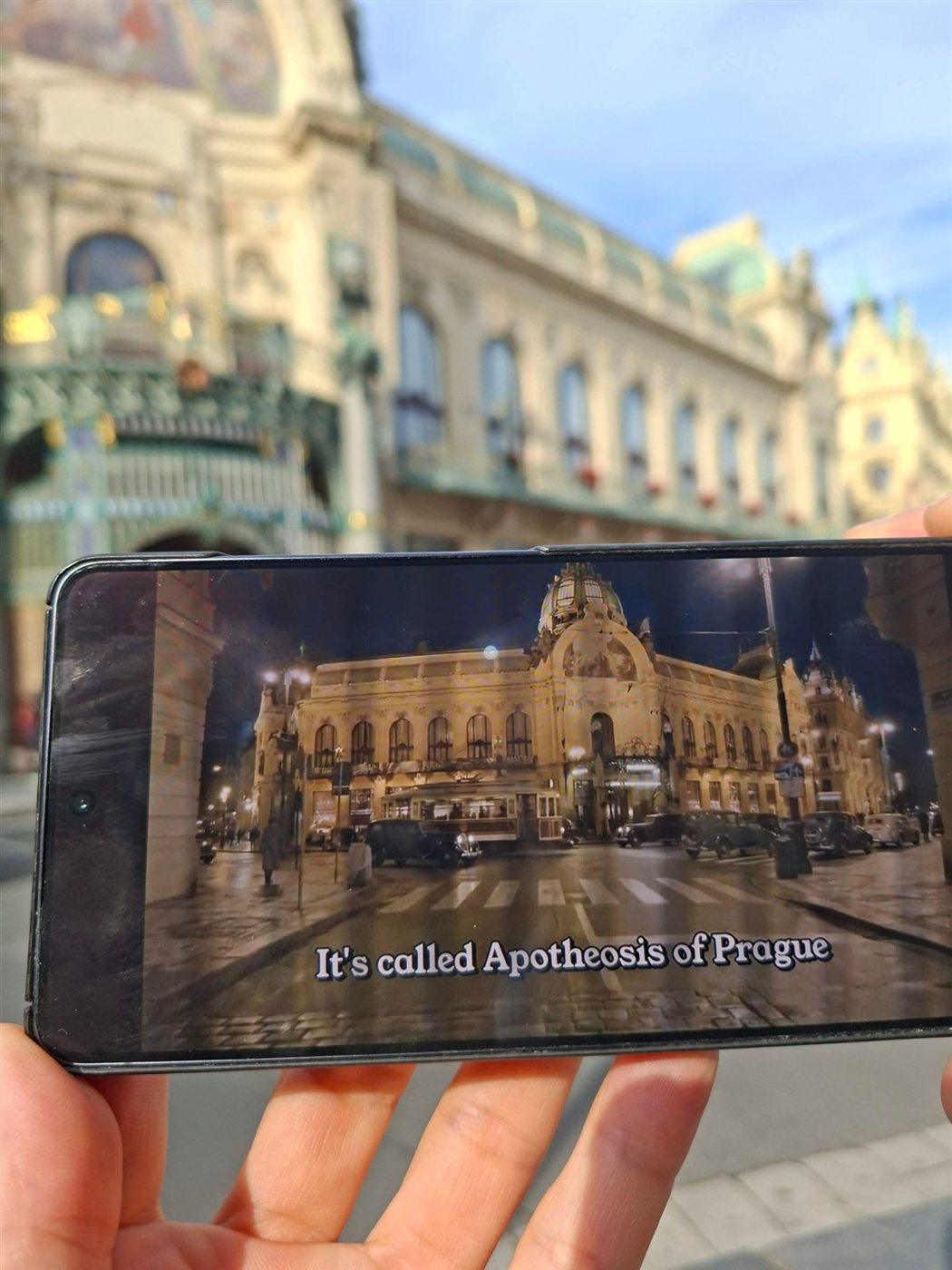 The Municipal House scene on a phone in front of the Municipal House: “It’s called Apotheosis of Prague”